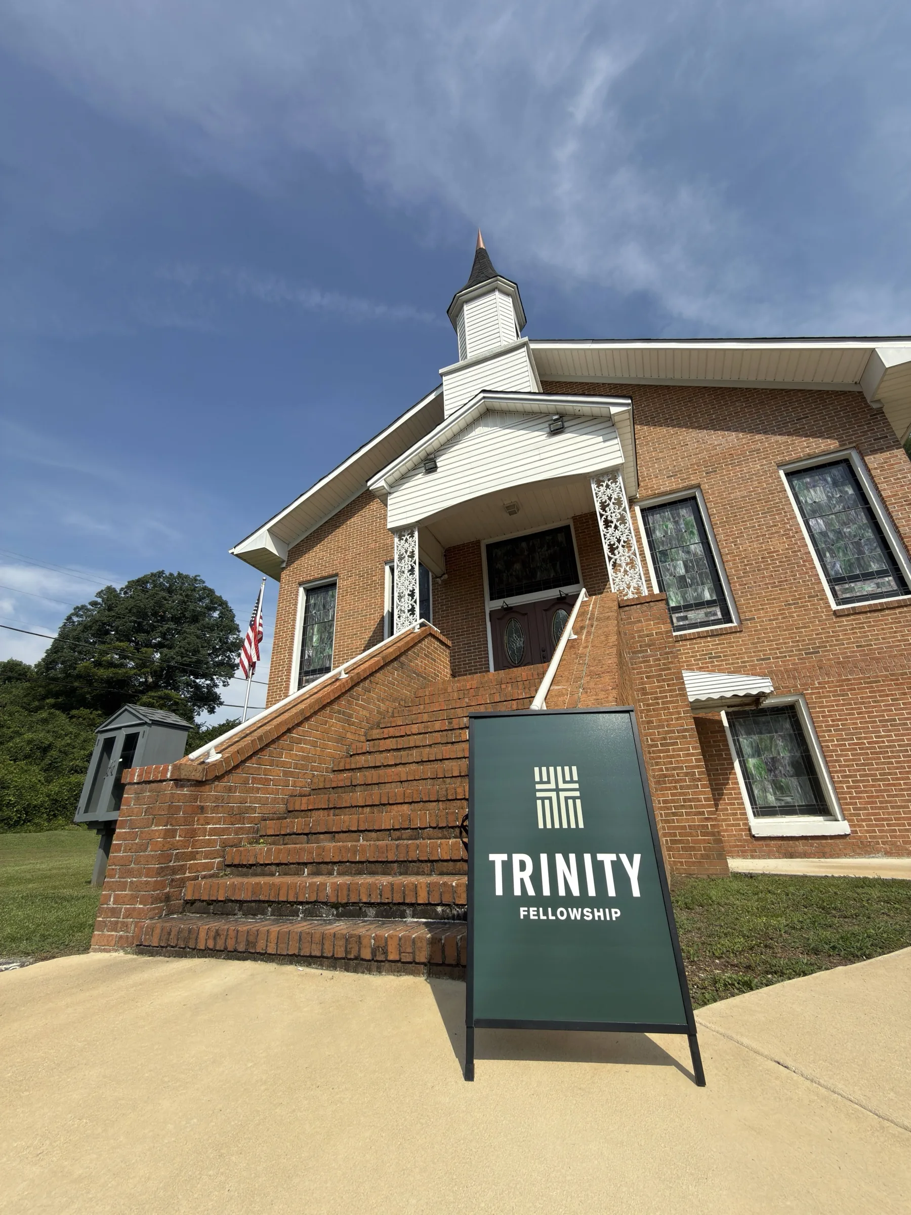 The brick entrance and Trinity Fellowship sign outside Fulton Springs Methodist Church.
